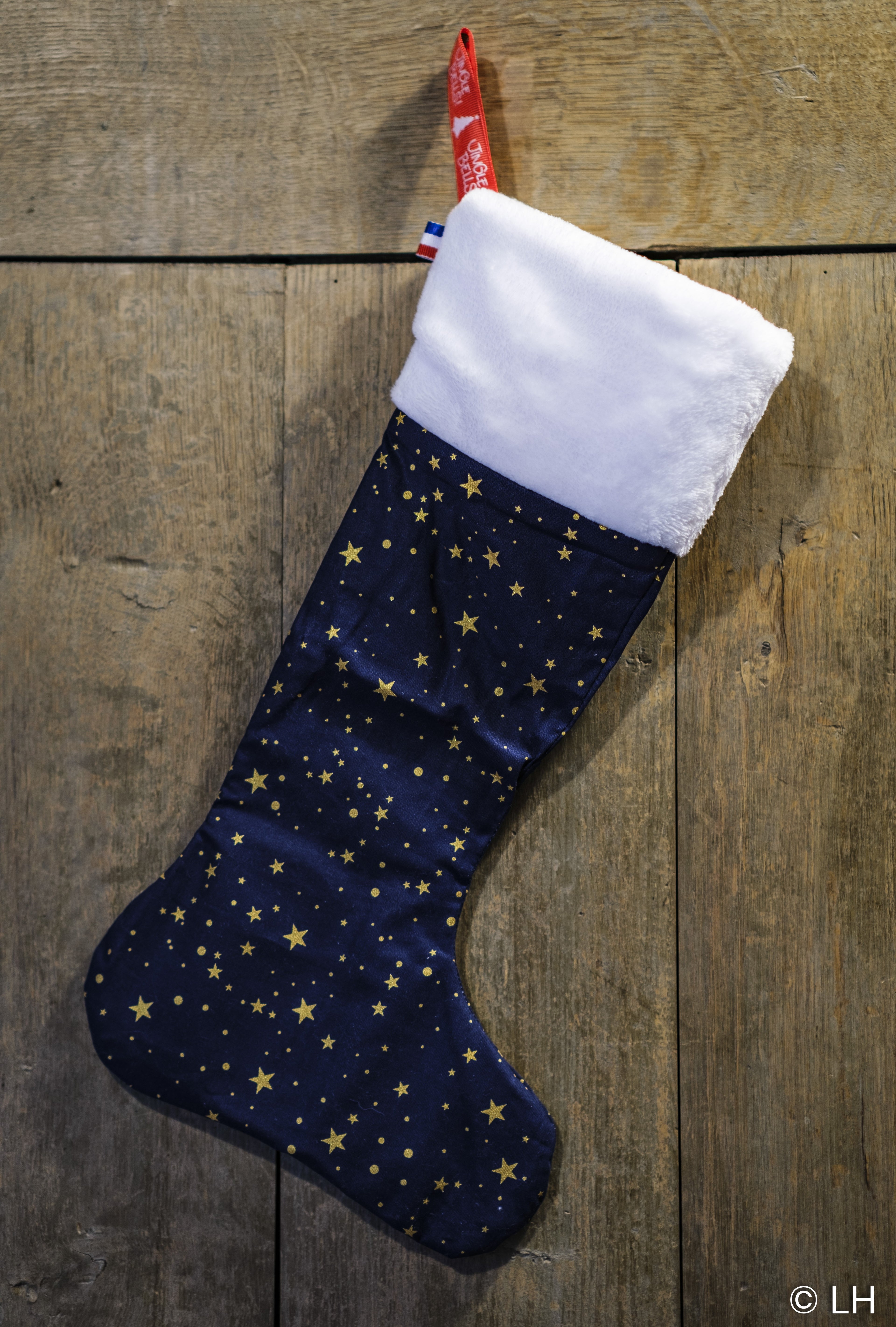 Botte de Noël bleu profond aux motifs étoiles dorées